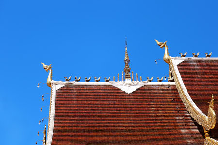 Thai style roof of Buddhist temple with blue sky.の写真素材