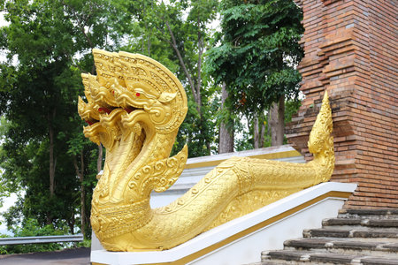 Naga statue for the entrance of the temple which the Buddhists believe to protect the door from bad things inside Wat Anarayo, Phayao Provinceの写真素材