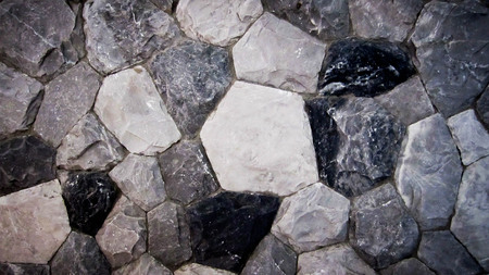 Background. The texture of the stone wall of the large rounded boulders