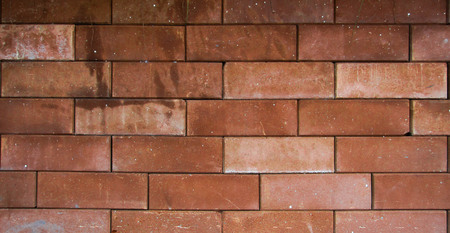 Brown brick wall On the street.can be used as backgroundの写真素材