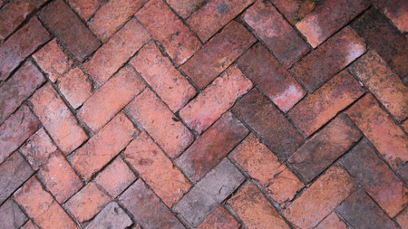 Alternately laying of red and brown floor tiles.Can be used as background.