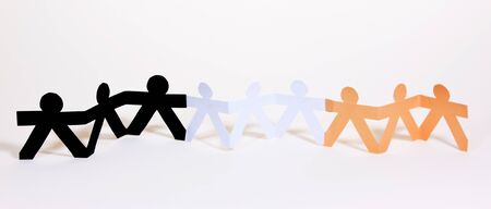 Paper cut into people hold their hands connected show human race equality on white background の写真素材