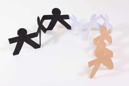 Paper cut into people hold their hands connected show human race equality on white background の写真素材