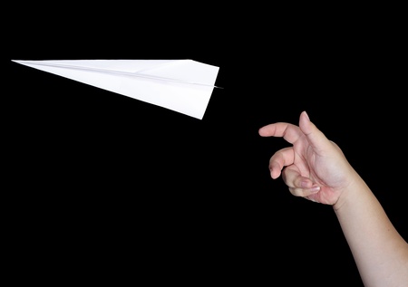 Handmade white origami paper plane isolated on black backgroundの写真素材