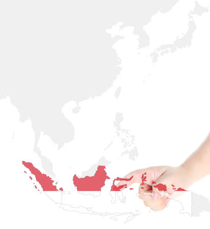Finger touch on Indonesia map flagの写真素材