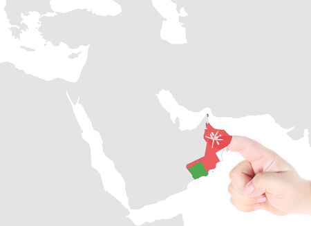 Finger touch on Oman map flagの写真素材