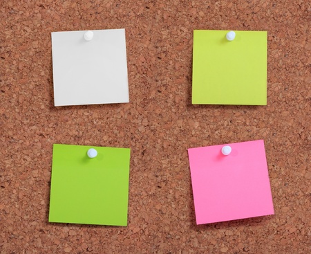 Colorful postit paper pin on cork board 