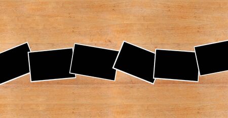 Blank photograph paper on wooden deskの写真素材