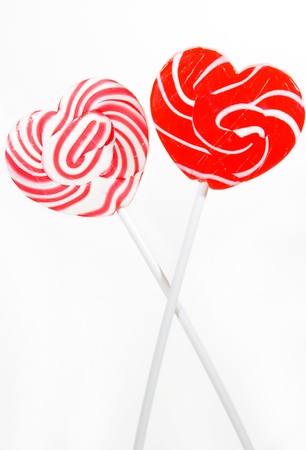 retro style red , pink heart shape lollipop on white backgroundの写真素材
