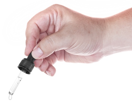 Medical glass dropper on white background の写真素材