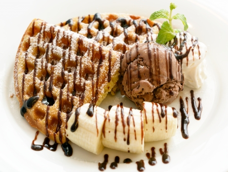 Chocolate banana waffle on white plateの写真素材