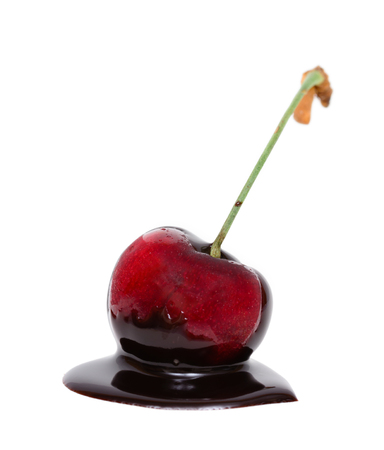 Red cherry in chocolate dipped isolated on white backgroundの写真素材