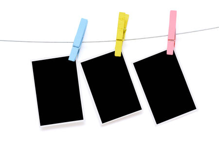 Colorful clothespin hang blank photo paper on white background