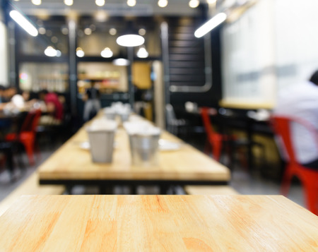 Wooden table and blur restaurant background