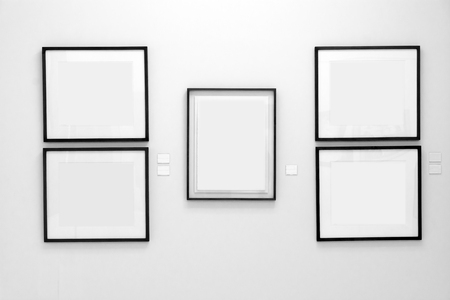 Black wood frames on white wallの写真素材
