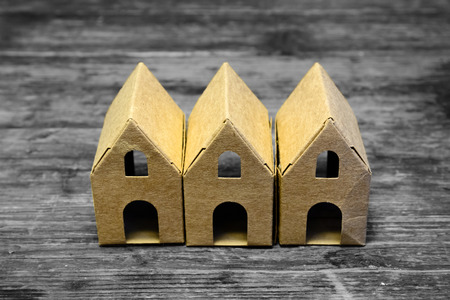 Recycle paper house on wooden table with vintage lookの写真素材