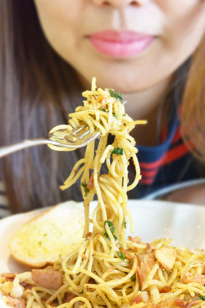 Eating spicy spaghetti bacon and chilliの写真素材