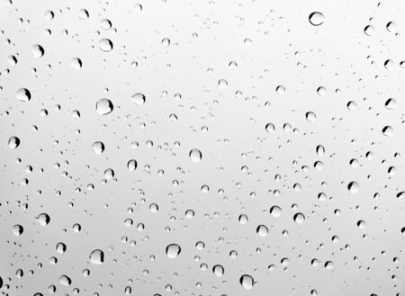 Drops of rain on car glass windowの写真素材