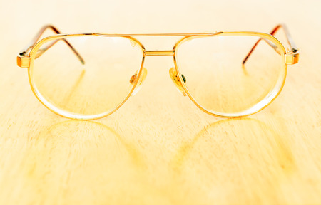 Vintage eye glasses on wooden tableの写真素材