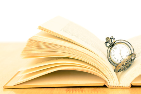 Vintage old pocket watch and bookの写真素材
