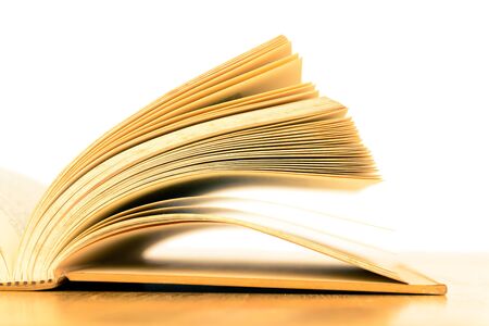 Opened vintage old book on wooden tableの写真素材