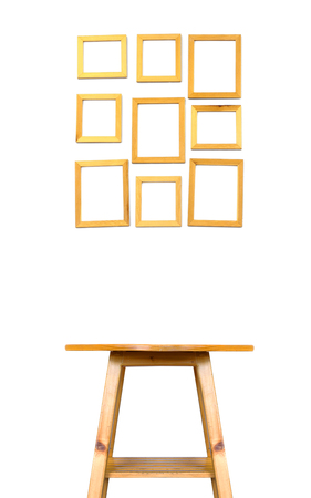 Wooden picture frame and table on white wallの写真素材
