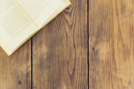 Vintage book open on wooden table with copy spaceの写真素材