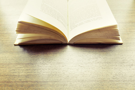 Vintage book open on wooden table with copy spaceの写真素材