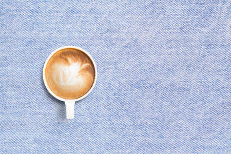 Coffee cup on jean tablecloth background top view flat lay copyspaceの写真素材