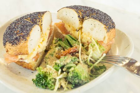 Salmon bagel with saladの写真素材