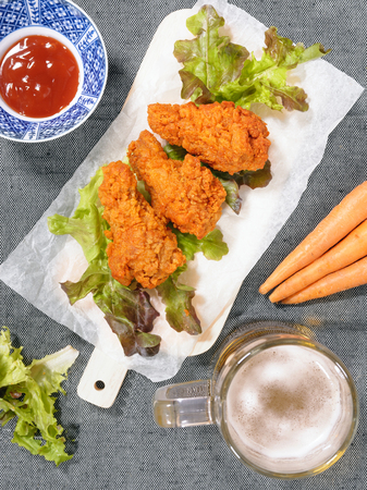 Fried chicken wing with beer and carrotの写真素材
