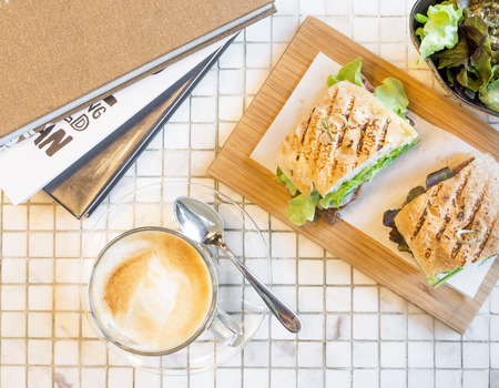 Hot coffee latte with roast beef french bread sandwichの写真素材