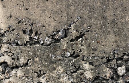 Cracked old dirty cement stone wall background textureの写真素材