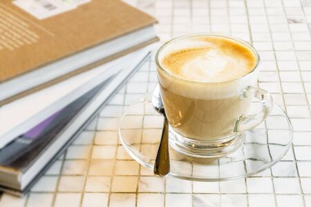 Hot coffee latte cup on white marble tile tableの写真素材