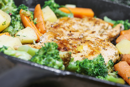 Lemon grilled chicken breast with fried vegetables in panの写真素材