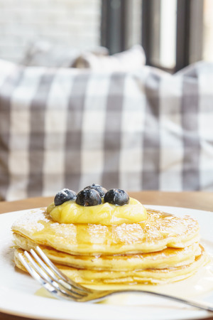 Lemon curd pancake on vintage wooden tableの写真素材