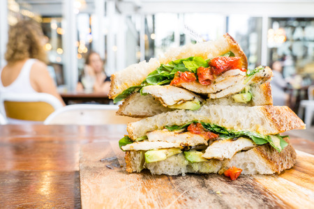 Chicken sandwich with avocado and tomatoの写真素材