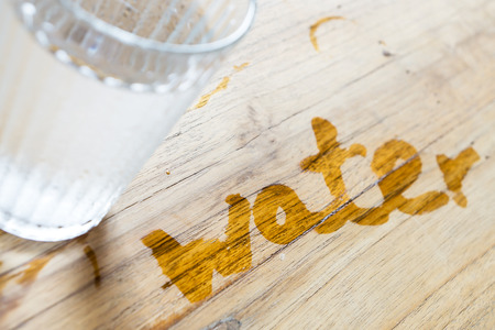 water word handwriting on wooden tableの写真素材