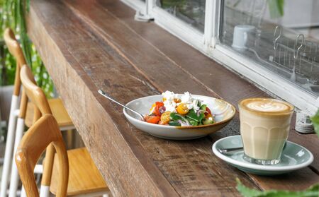 Greek salad and coffee latte for breakfastの写真素材