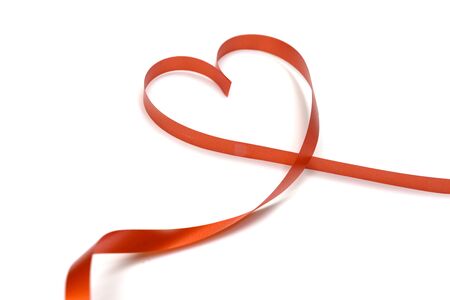 red ribbon heart shape isolated on white backgroundの写真素材