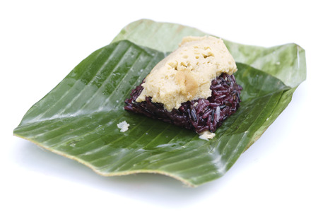 Thai custard sticky black rice dessert on banana leaf isolated on white backgorundの写真素材