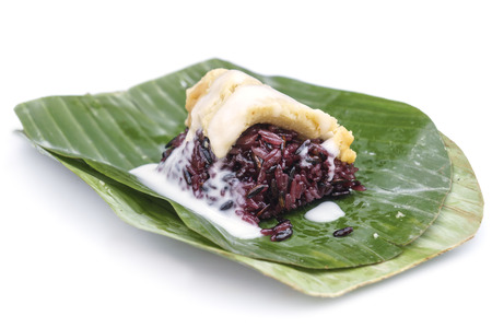 Thai custard sticky black rice dessert on banana leaf isolated on white backgorundの写真素材