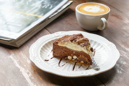 Chocolate cake and hot coffee latte on vintage wooden tableの写真素材