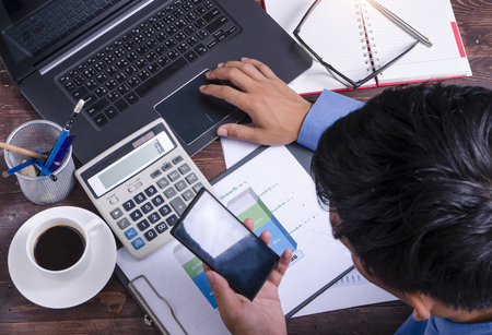 businessman hand working with new modern computer and business strategy as concept,selective focus,flare lightの写真素材