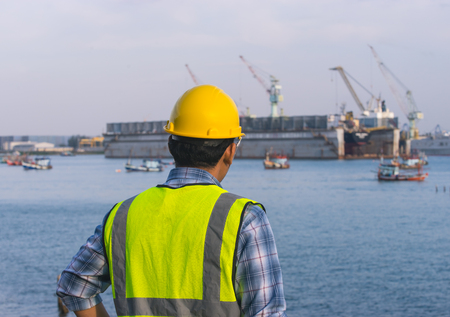 man inspect container in port