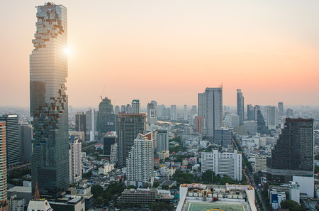 Aerial view of Bangkok modern office buildings, condominium in Bangkok city downtown with sunset sky...