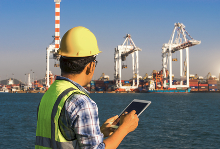 Businessman use tablet at port import and export shipping