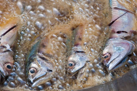 Fish frying in hot oil.