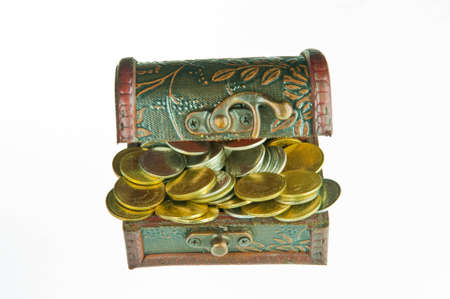 Old style wooden box full with gold money isolated on white background.の写真素材