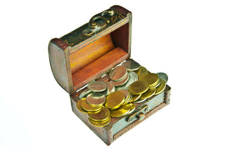 Old style wooden box full with gold money isolated on white background.の写真素材